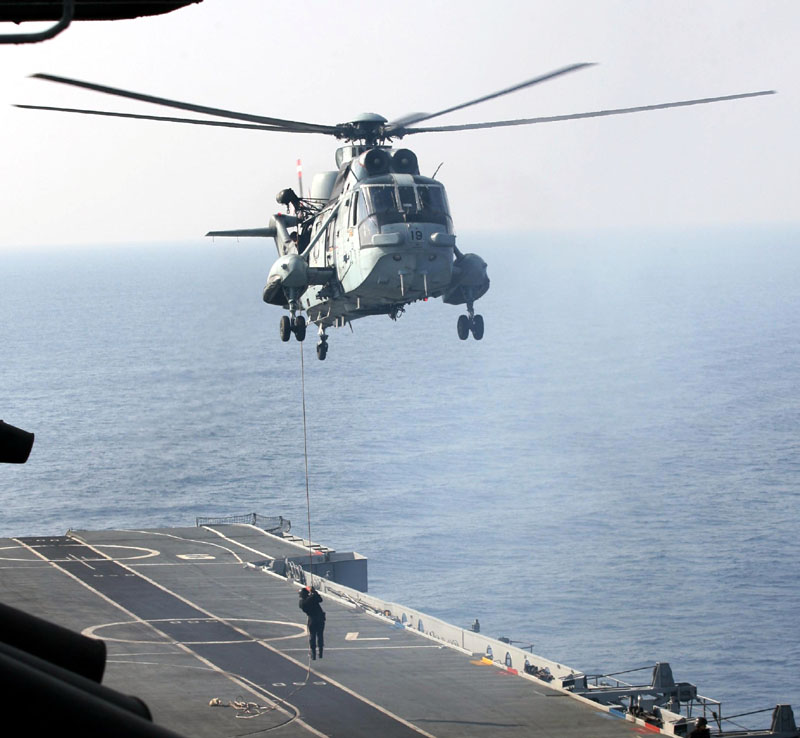 A Naval Commando slithering from a Sea King helicopter, during the Naval Exercise TROPEX-2012