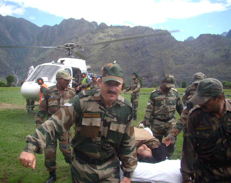 The Army Jawans and Armed Forces Medical Services personnel are carrying flood victims..