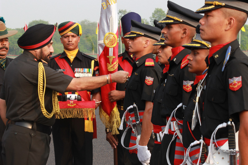 The Chief of Army Staff, General Bikram Singh presenting medal to a cadet at the Passing out..