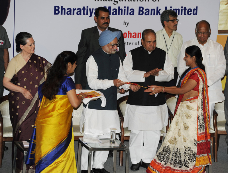 The Prime Minister, Dr. Manmohan Singh presents the new account kit to the first...