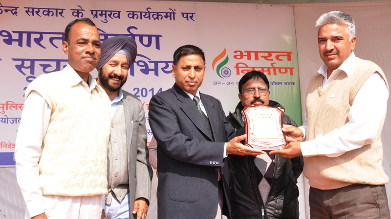 The ADC, Sirsa, Shri Shiv Prasad Sharma presenting award to Red Cross Society...