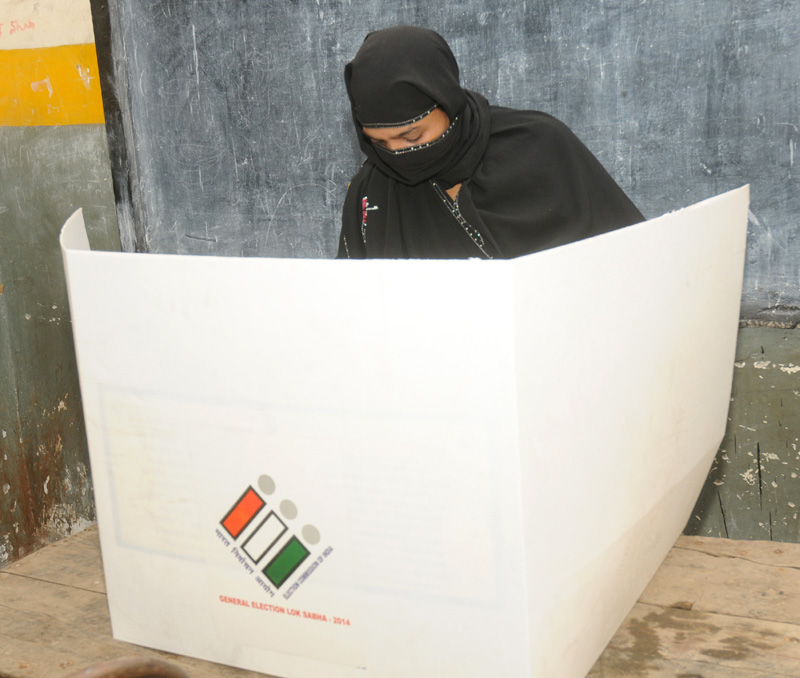 A Muslim Female voter casting her vote, at a polling booth during the 3rd Phase of General Elections-2014, in Delhi