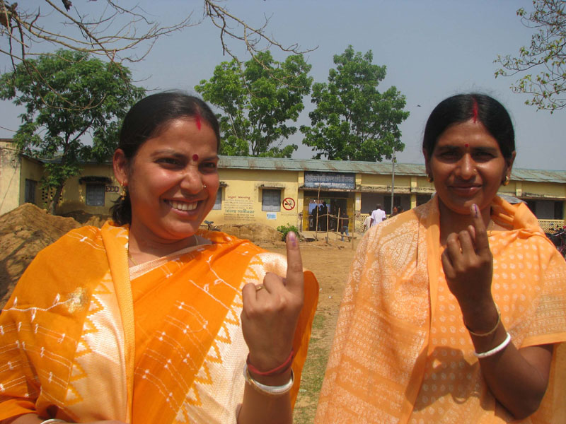 Two female voters showing mark of indelible ink after casting her vote,...