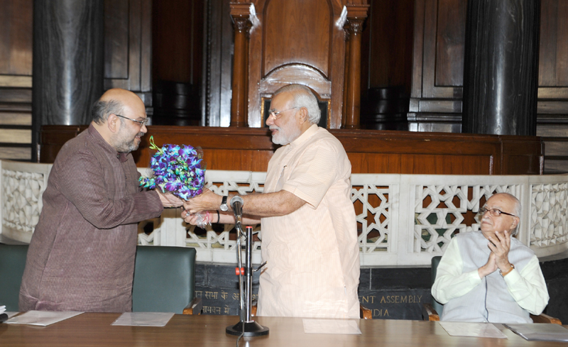 The Prime Minister, Shri Narendra Modi presenting a bouquet to the…