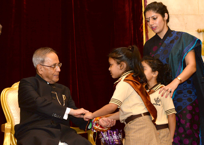 Children tying ‘Rakhi’ to the President, Shri Pranab Mukherjee, on the occasion...
