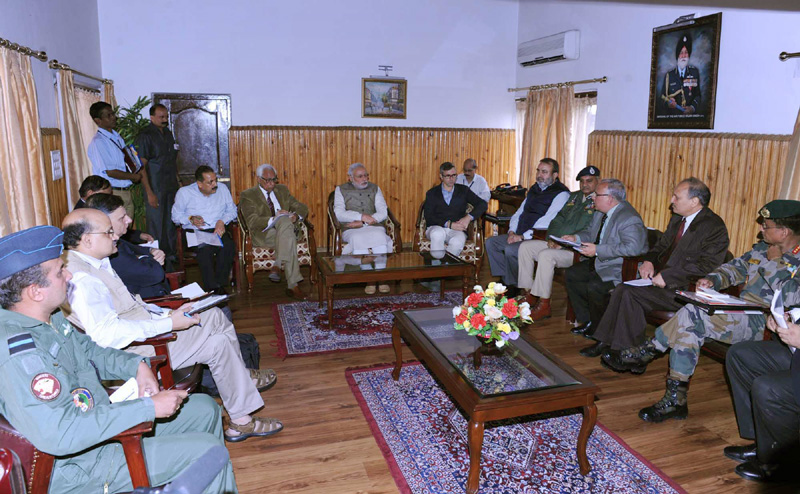 The Prime Minister, Shri Narendra Modi presiding the meeting at Srinagar to ...