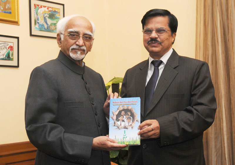 The Vice President, Shri Mohd. Hamid Ansari being presented a book titled..