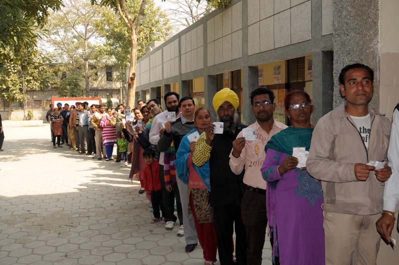 A long queue of voters to cast their votes for the Delhi Assembly Election, in New Delhi